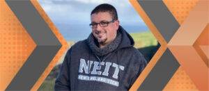 Portrait of Shaun Hazard framed by an orange and gray geometric background.