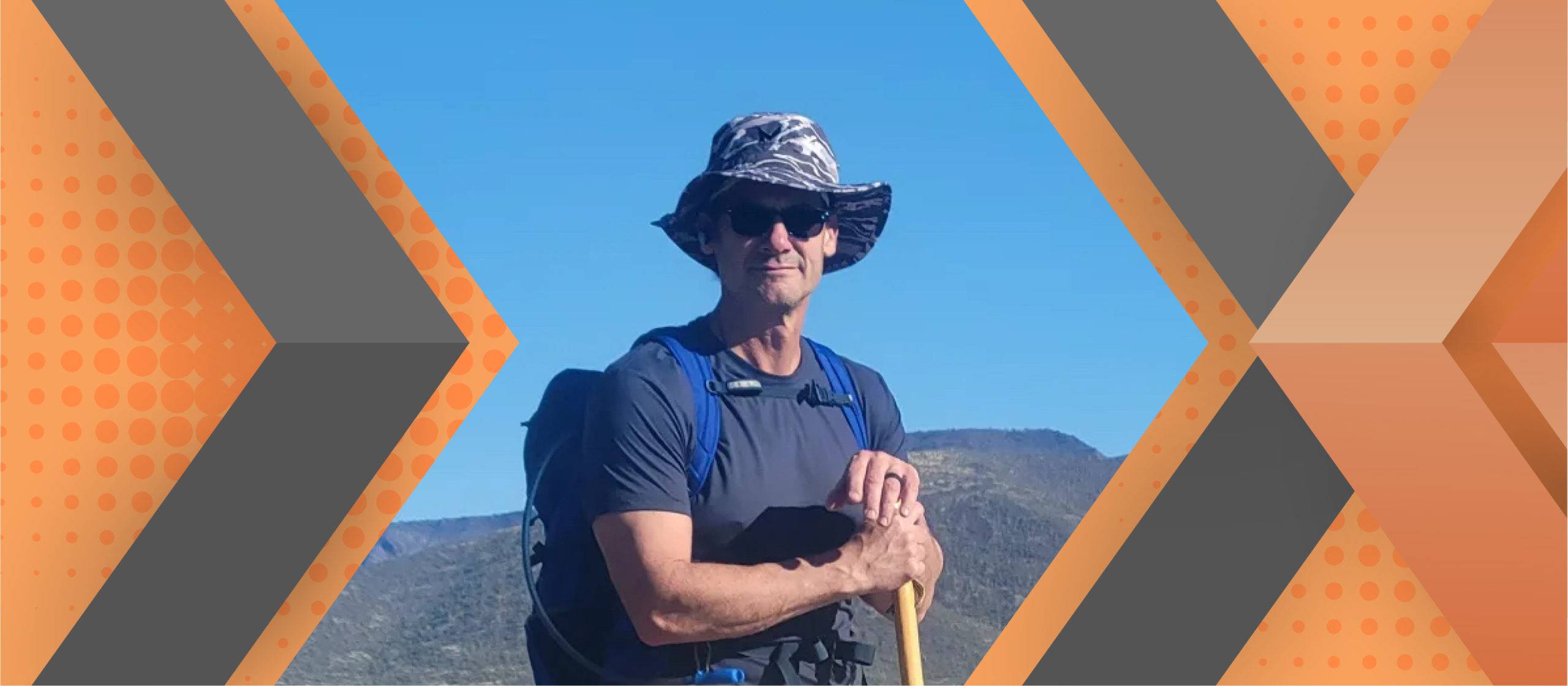 Portrait of Allen Heil framed by an orange and gray geometric background.