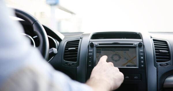 Man using modern navigation system while driving car