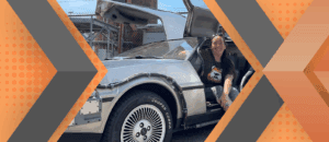 Portrait of Laura Marzilli and her car framed by an orange and gray geometric background.