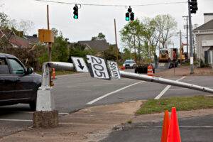City street after tornado showing light pole bent at 90 degrees