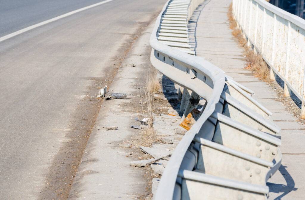 Car crash accident site. Damaged fence on the bridge from car crash accident. Selective focus. Bridge damage.
