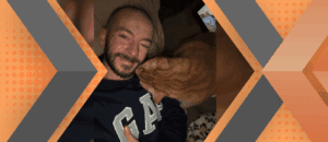 Portrait of Charles Cardella framed by an orange and gray geometric background.