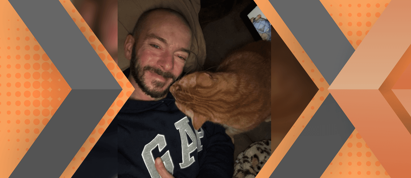 Portrait of Charles Cardella framed by an orange and gray geometric background.