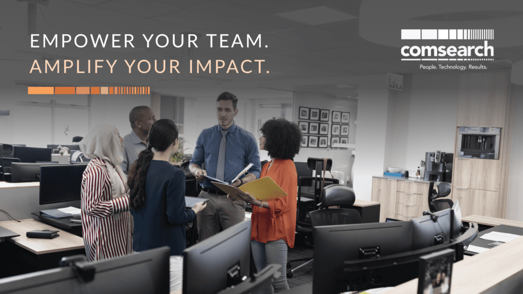 Diverse group of business professionals collaborating in an office, with Comsearch tagline ‘Empower your team. Amplify your impact.’
